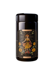 A black tea tin labeled "Magic Hour" featuring the design "The Sun." The tin showcases a vibrant illustration of a woman in a flowing dress, surrounded by sunflowers and celestial elements, with hints of Moringa. The phrase "Tea for Prosperity" is inscribed at the bottom.