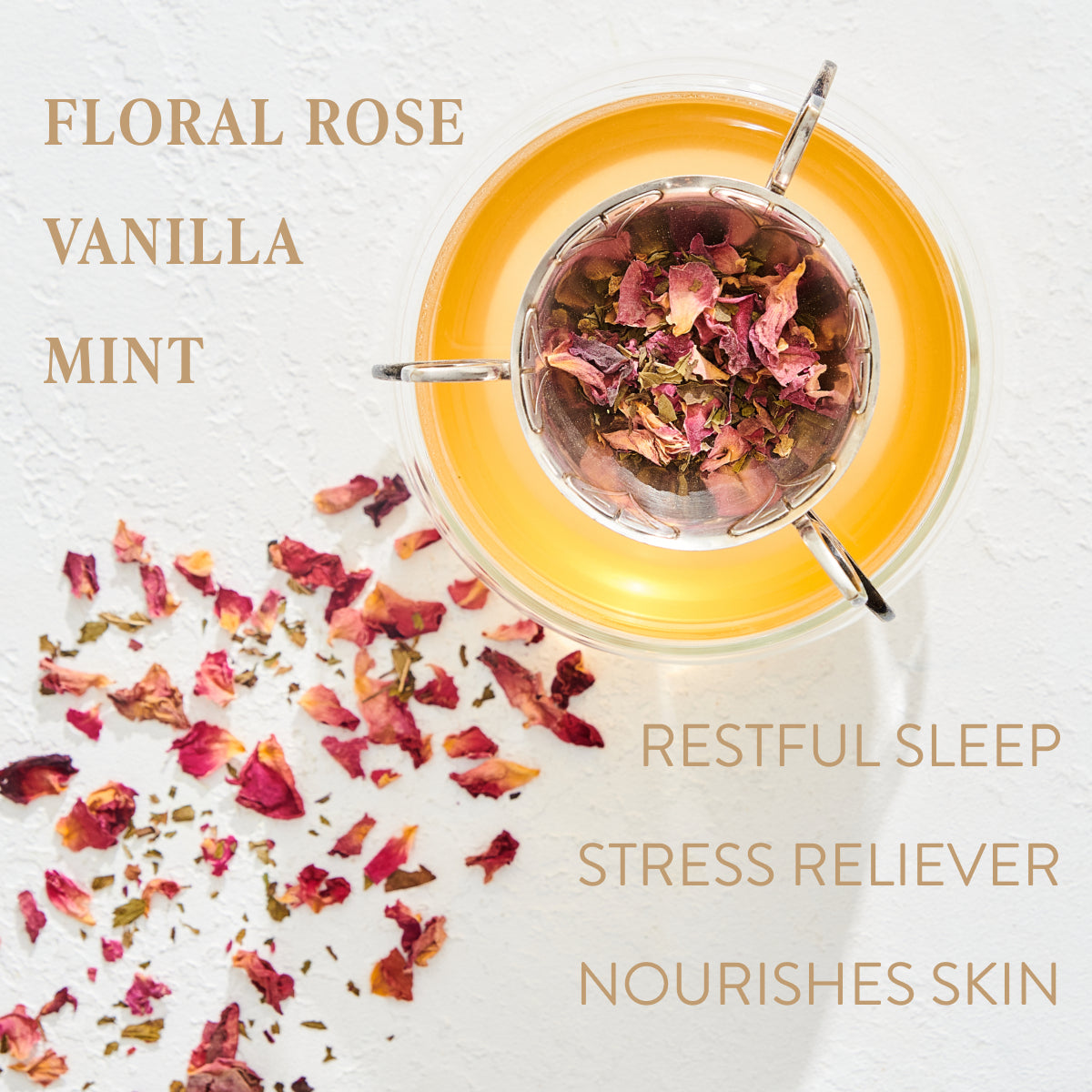 A cup of tea with rose petals in a tea infuser sits on a white surface. Dried rose petals are scattered around the cup. Text on the left reads &quot;FLORAL ROSE VANILLA MINT,&quot; and on the right, &quot;RESTFUL SLEEP STRESS RELIEVER NOURISHES SKIN.&quot; Enjoy this soothing organic loose leaf Mantra Mint™ Herbal Tea from Club Magic Hour.