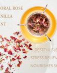 A cup of tea with rose petals in a tea infuser sits on a white surface. Dried rose petals are scattered around the cup. Text on the left reads "FLORAL ROSE VANILLA MINT," and on the right, "RESTFUL SLEEP STRESS RELIEVER NOURISHES SKIN." Enjoy this soothing organic loose leaf Mantra Mint™ Herbal Tea from Club Magic Hour.
