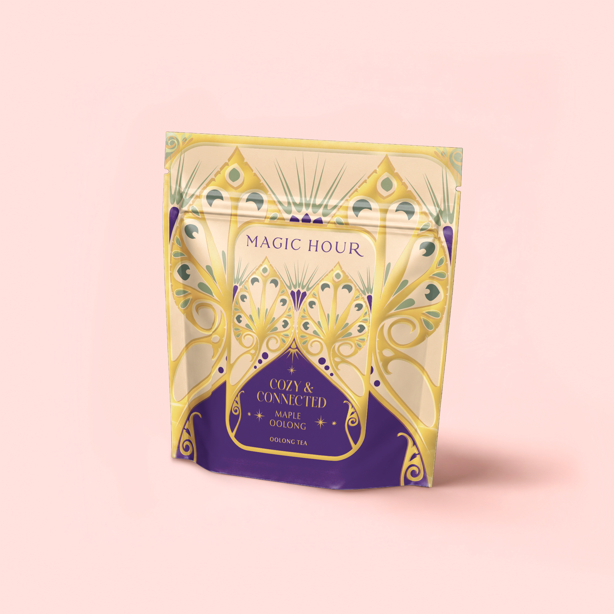 A standing pouch of Maple Oolong: Cozy & Connected, an autumn tea blend featuring ornate art deco-style gold and purple designs on a light pink background.