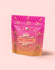A vibrant pink and orange resealable pouch labeled "Mercury Mint Daytime: Vanilla Mint Lavender Jasmine Black Tea," with decorative gold and white celestial designs—perfect for storing your favorite tea blend.