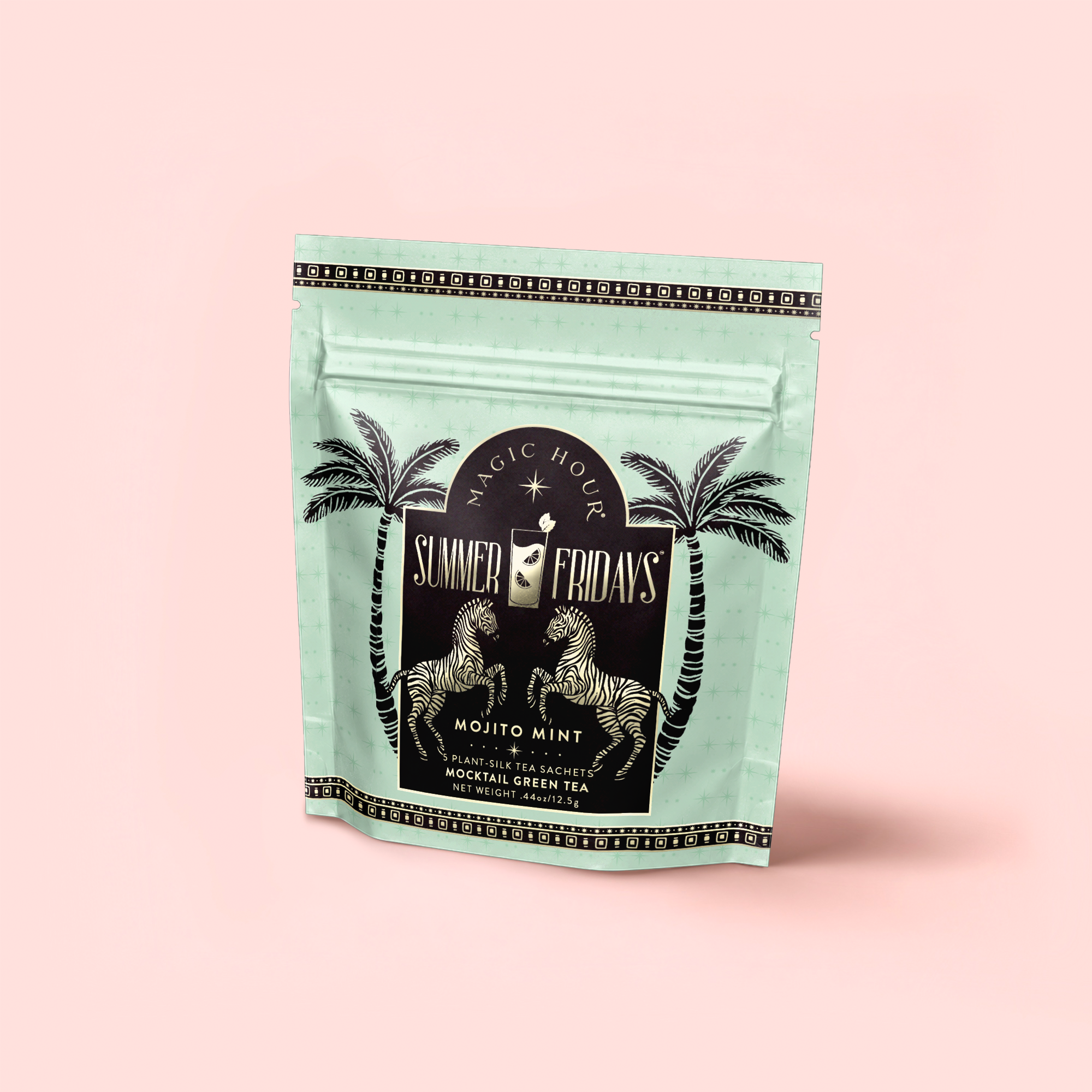 A mint-green resealable pouch labeled "Mojito Mint: Green Mint Mocktail Tea for Bright Moods & Celebrating Clarity" with two zebras and palm trees stands against a pale pink background, perfect for refreshing zero-proof cocktails.