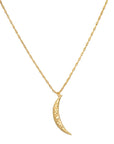 The Midnight Sky Pendant Moon Necklace showcases a delicate gold design with a thin, textured crescent moon pendant. The fine and simple chain elegantly complements the shiny, hammered 18kt gold finish of the moon charm. This necklace boasts a lightweight and minimalist design that subtly captures the essence of the celestial realm.