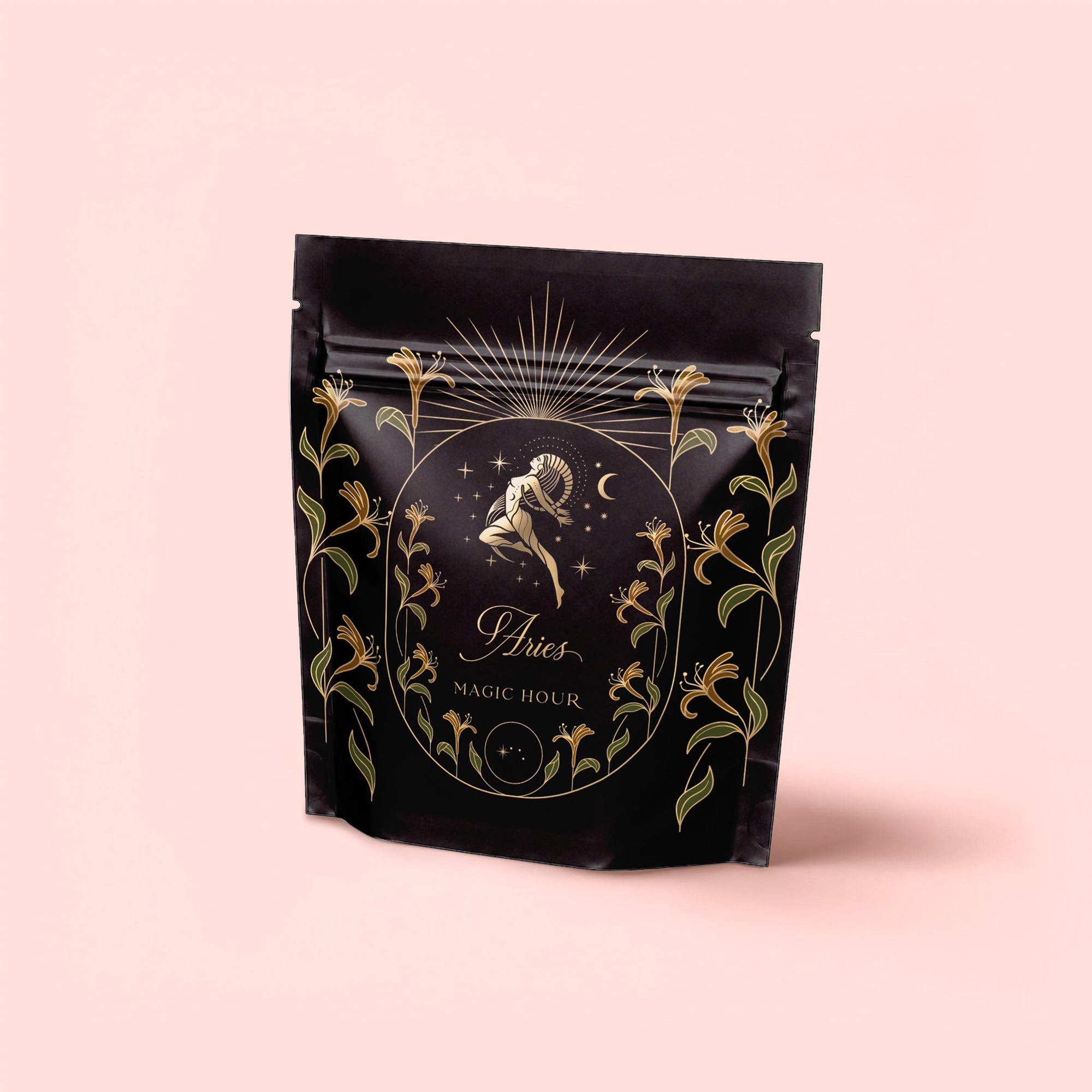 A black resealable pouch with gold and green floral designs shows a ram-headed figure and sunburst. The pale pink label reads "Aries - Garden of Eden Oolong," “Magic Hour,” and highlights Blackberry-Bergamot Earl.