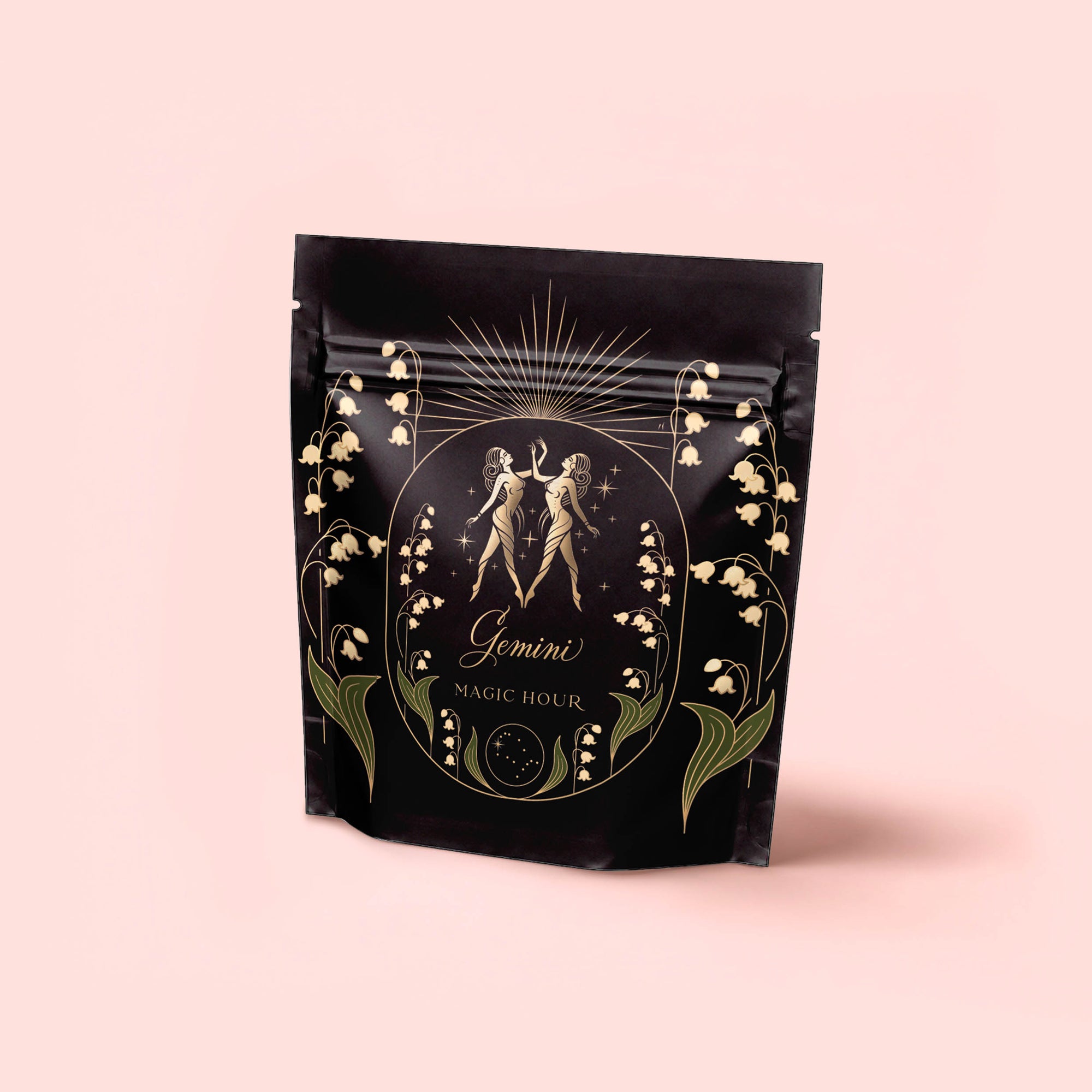 A black, resealable bag with gold and green Cancer-themed artwork featuring celestial accents and the text "Cancer: Queen of Cool Mango-Ginger-Cream White Tea" highlights mango and organic ginger against a pale pink background.