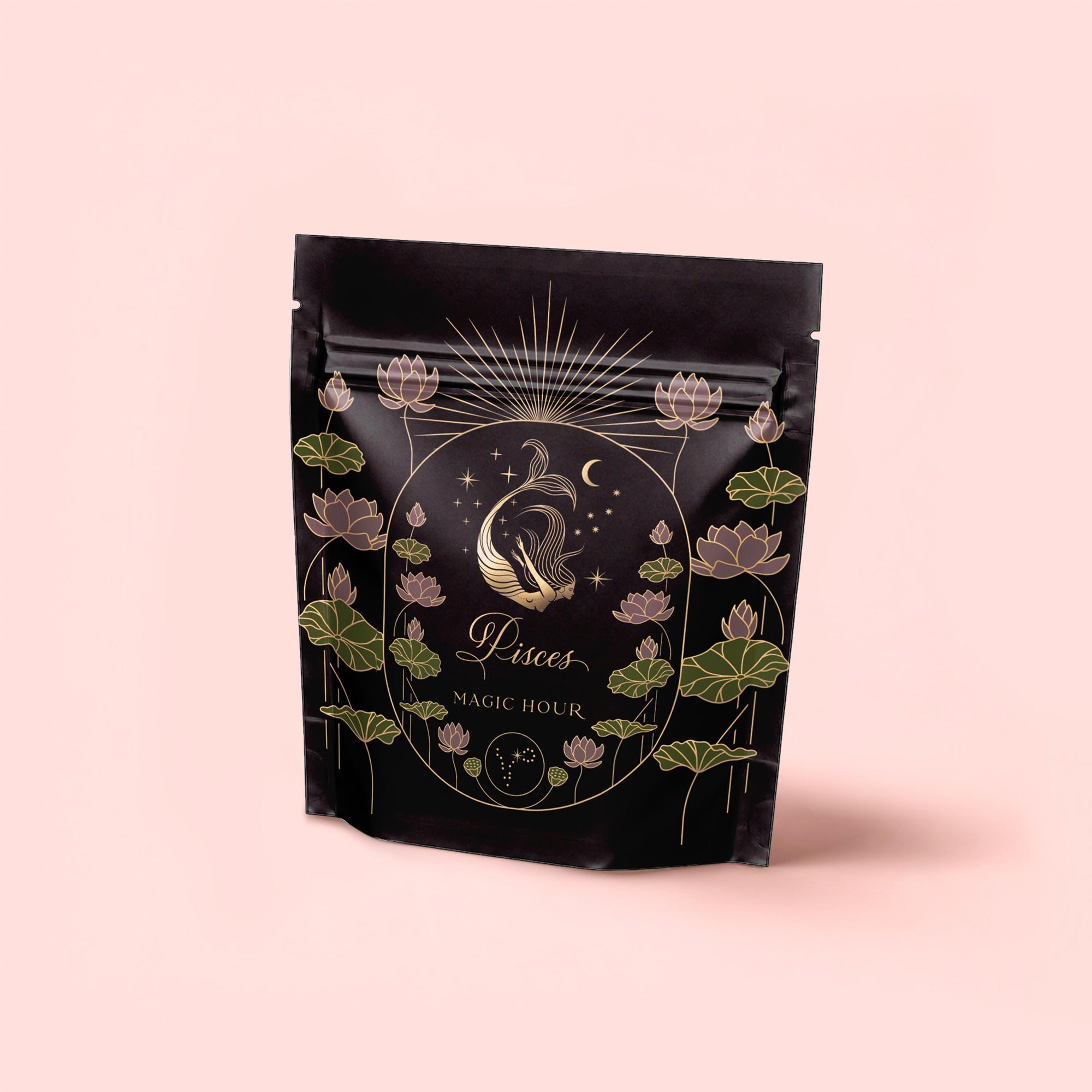 A black stand-up pouch with gold and pastel illustrations of a fish, lotus flowers, stars, and moons. The label reads "Pisces: Magnolia-Jasmine Blueberries & Cream Tea with Lion's Mane" in elegant script on a light pink background.