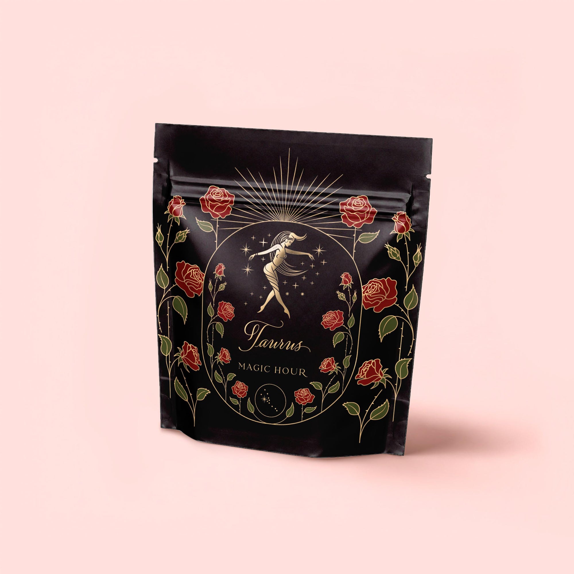 A luxury tea blend package, "Taurus: Tea of Venusian Garden Delights," features gold and red art—dancing woman, roses, sun rays, and crescent moon—on pale pink. Elegant antioxidant tea for those who cherish beauty and sophistication.