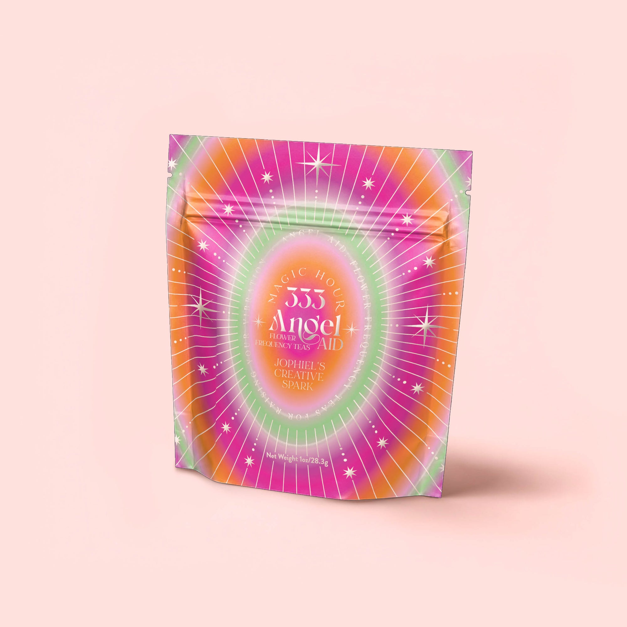 A vibrant, resealable pouch with a lively starburst design in pink, orange, and green says "333: Mango-Lemon Balm-Rose Herbal Tea with Passionflower" and stands upright on a pale pink background.