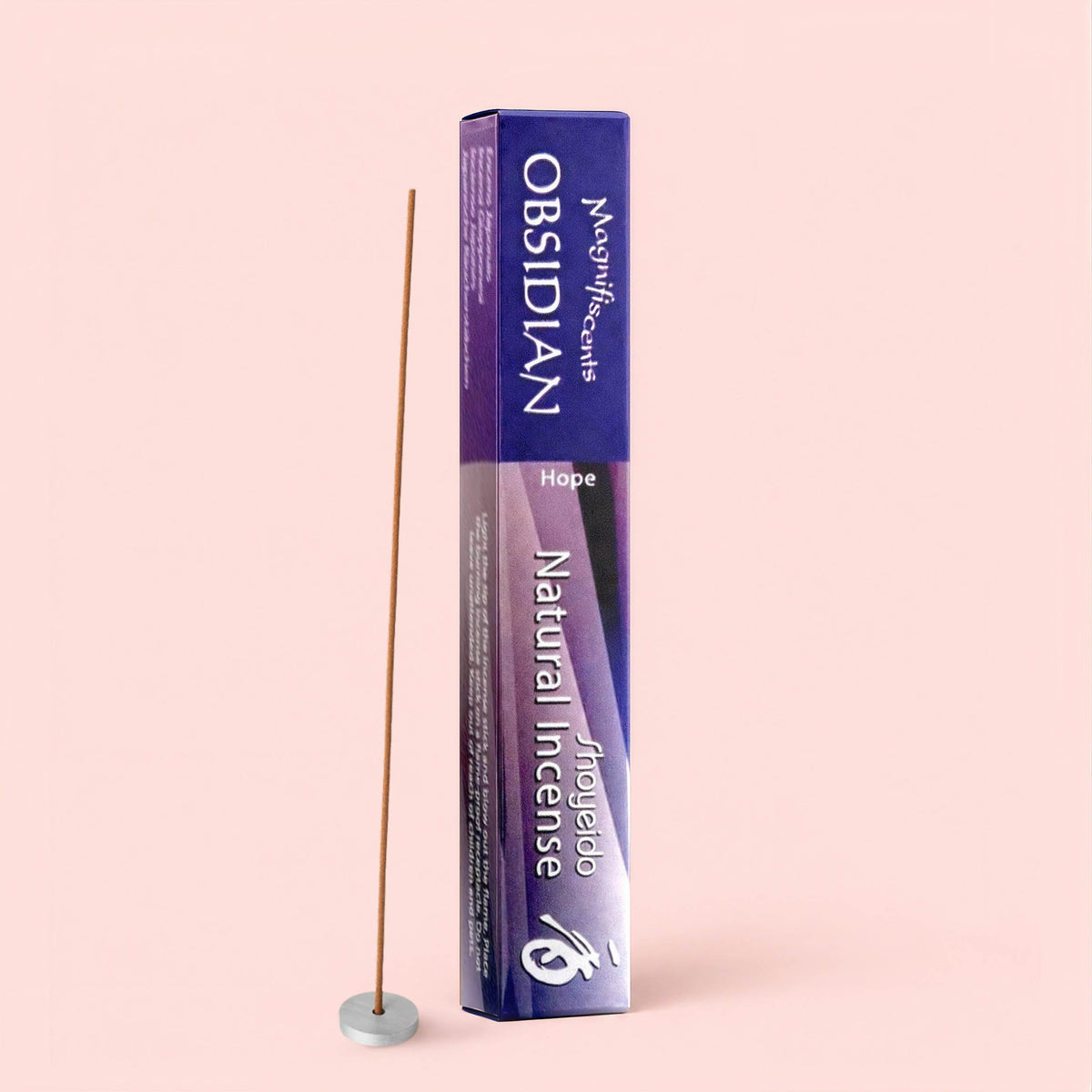 A box of Natural Incense : Obsidian labeled “Hope” stands upright beside a lit incense stick releasing calming sandalwood notes from a small round holder—all set against a pale pink background.