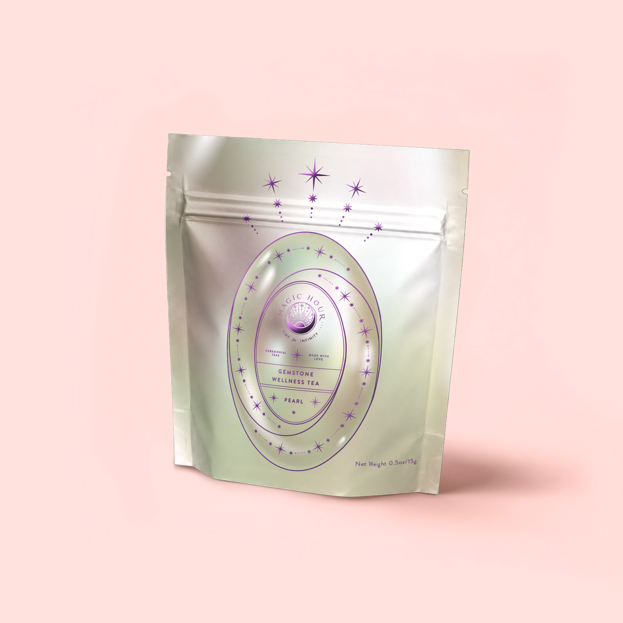 A silver, resealable pouch with a pastel magical design features stars and a round label reading "Pearl Tea of Beauty, Clarity, and a Sense of Peace" against a soft pink background.