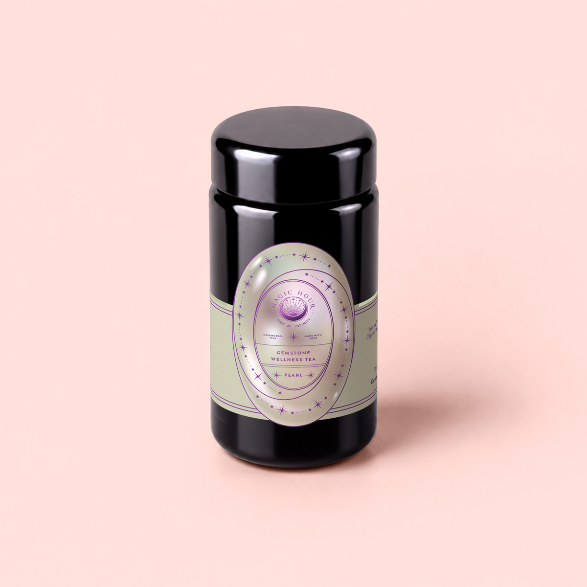 A black tea canister labeled “Pearl Tea of Beauty, Clarity, and a Sense of Peace,” adorned with pastel green and lavender accents and featuring soothing Tulsi and organic chamomile, sits on a light pink background.