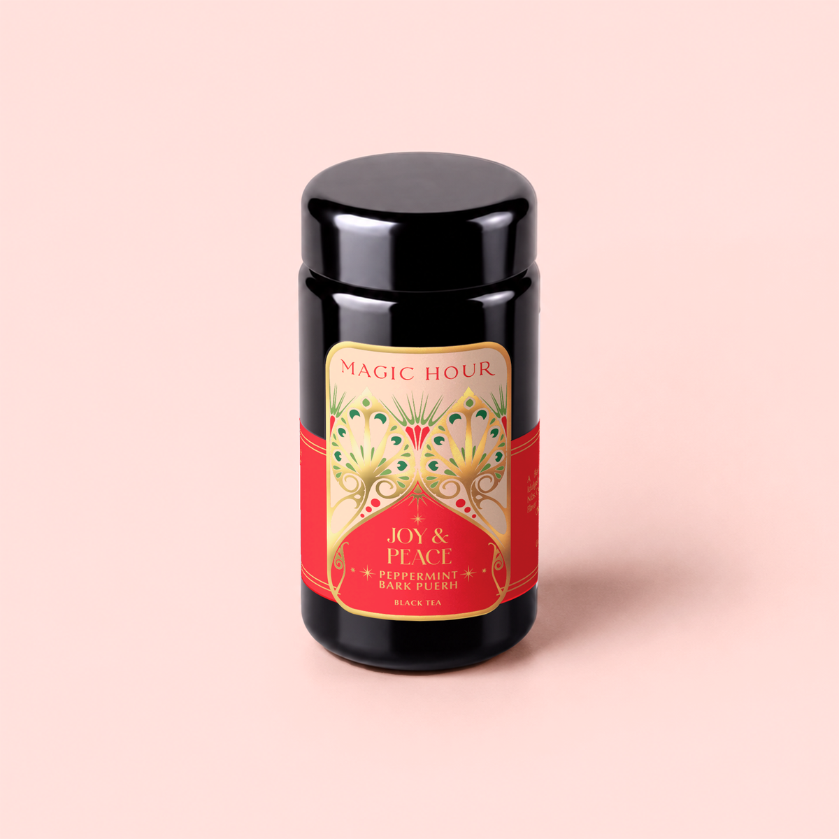 A canister of Peppermint Bark Puerh tea stands upright on a pale pink background, its red and gold label promising the rich aroma and metabolism-boosting benefits of this dark chocolate peppermint blend.