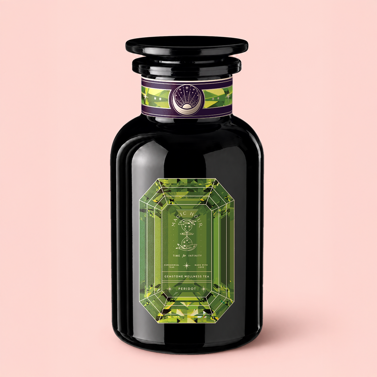 Set against a light pink background, the elegant Peridot: Green Guayusa Oolong Mango-Peach Tea comes in a black glass bottle adorned with a green, gem-shaped label and a decorative purple band near the cap. Inside, you’ll find an invigorating blend of organic guayusa and oolong tea infused with luscious mango and peach flavors.