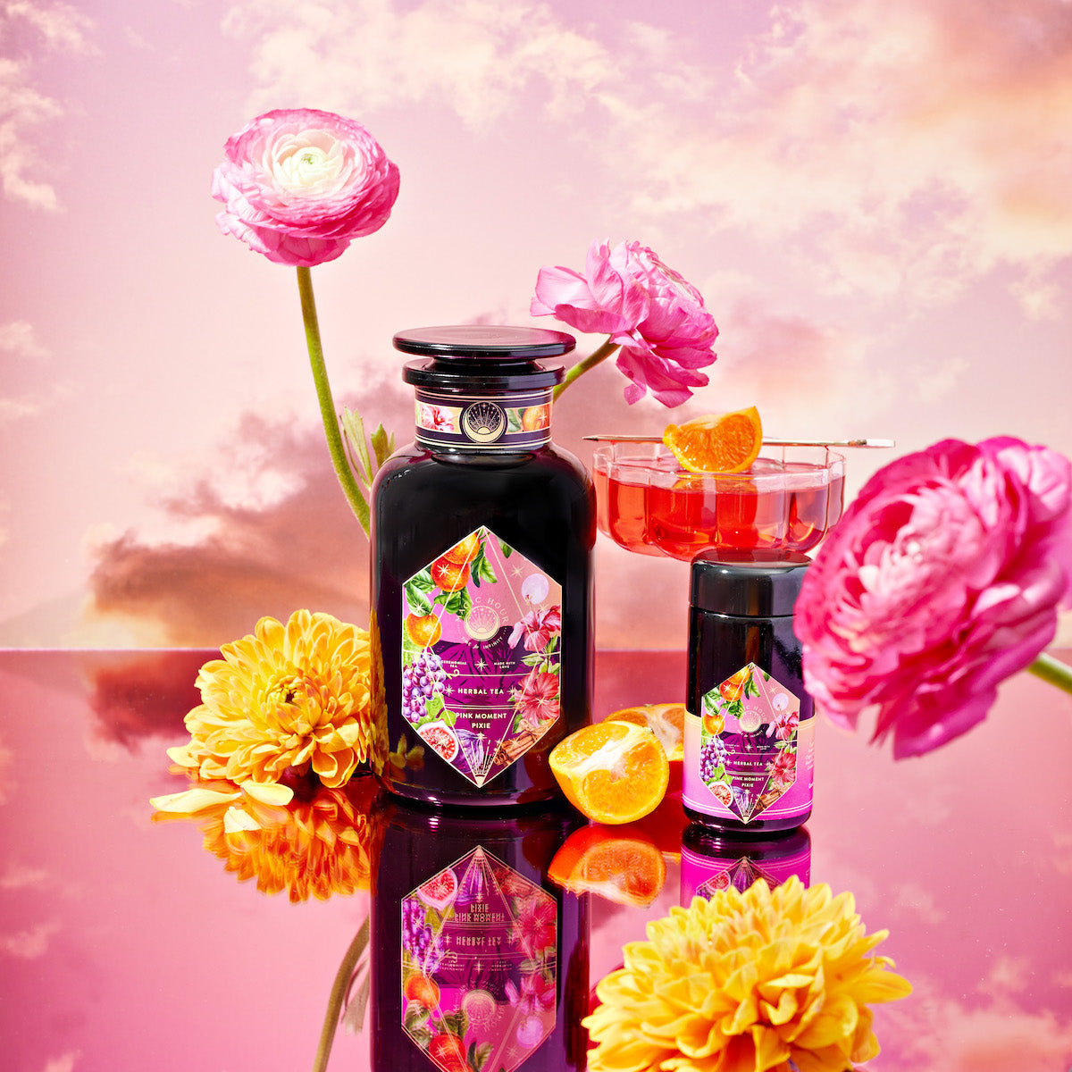 A beautiful dream like image of pink moment pixie tea in a jar with a pink sunset in the background.