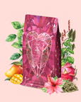 A gem-patterned pink bag of Pink Tourmaline: Organic Dragon fruit Hibiscus White Tea for Women's Health is displayed amidst illustrated mango, dragon fruit, hibiscus flowers, tea leaves, and lush green foliage on a soft pink background—specially crafted to support Heart & Breast Health and provide natural Immune Support.