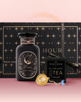 The Pisces Astrology Tea Gift Set includes a "Pisces" tea jar, a black box of opal moon ritual tea, an Opalite Moon Tea Strainer, and comes in pink gradient packaging with gold stars.