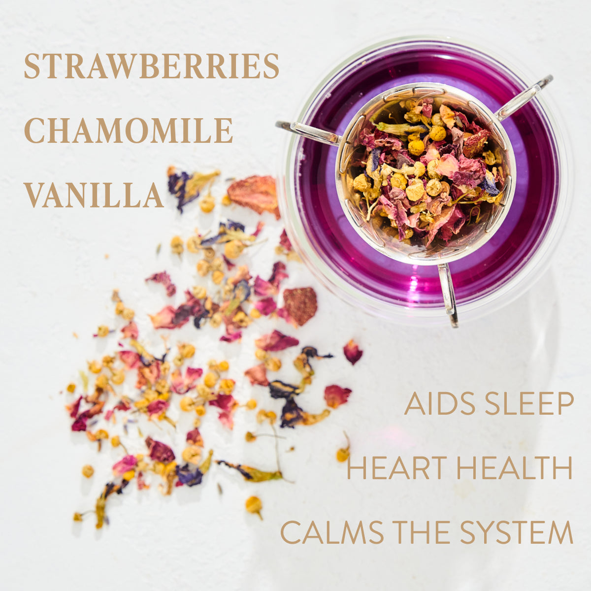 A glass cup of Magic Hour's Queen of Ukraine: Spring Blossom Tea sits on a white surface. The tea, a mix of dried strawberries, chamomile, and vanilla flowers, has some scattered around the cup. Text on the image lists ingredients and benefits: "Aids Sleep," "Heart Health," and "Calms the System." Experience the magic hour with every sip.