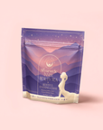 A lavender and peach tea packet labeled "Restful Evening Chai: Dosha Balancing Saffron Spice Tea" features a woman's silhouette, mountains, and stars, offering relaxation and gentle purification.
