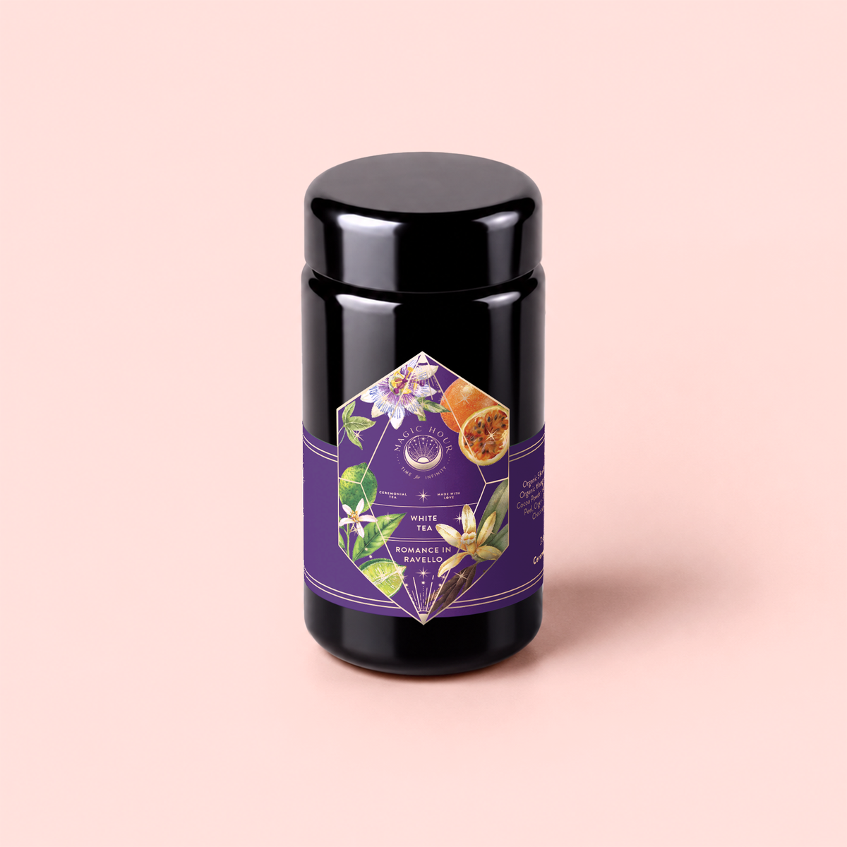 A canister of Romance in Ravello - Chocolate-Passionfruit-Rose-Cream White Tea sits on a pale pink background, its purple floral label adorned with passion flowers and fruit, evoking inspiration from the Amalfi Coast.
