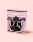 A pink resealable pouch labeled "Rosé All Day: Herbal Tropical Flower Mocktail Tea for Slim Summer Sips" features black, gold, and white palm tree and leopard designs, and contains an alcohol-free rose mocktail tea.