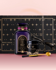 The Tea & Honey Gift Set features a luxurious black and gold starry design, with a large "Magic Hour" bottle, wildflower honey, and a gold honey dipper—perfect for your morning ritual—all arranged on a pink surface.