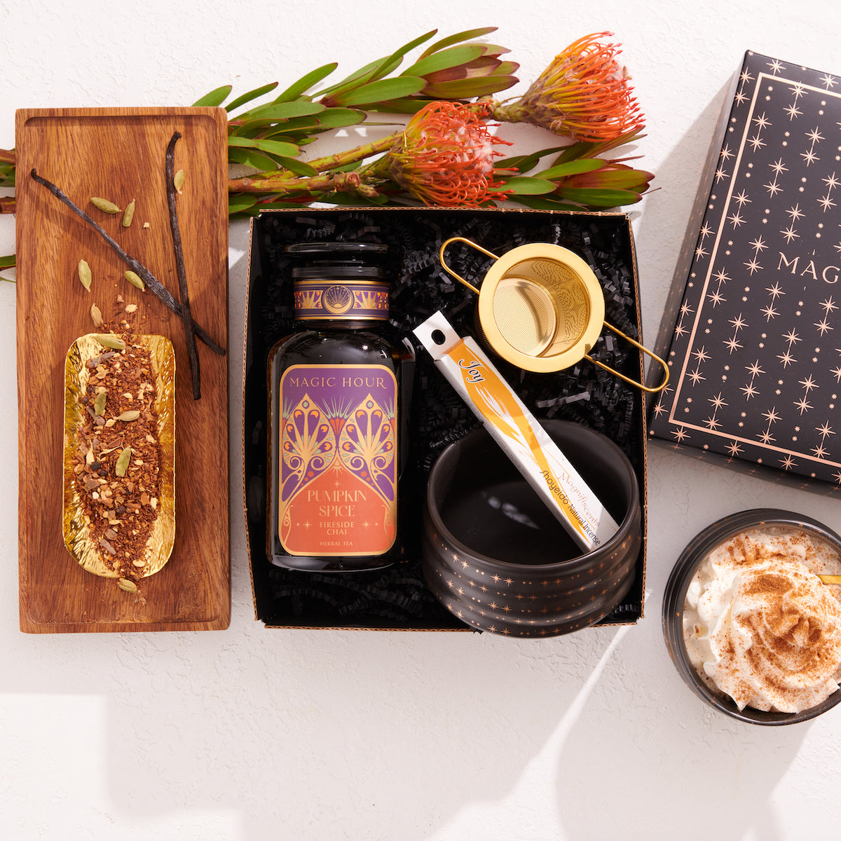 Beautiful gift box with a gold tea strainer, joy incence, a ceremonial tea bowl, and a Violet Glass Apothecary Jar with Pumpkin Spice Fireside Chai