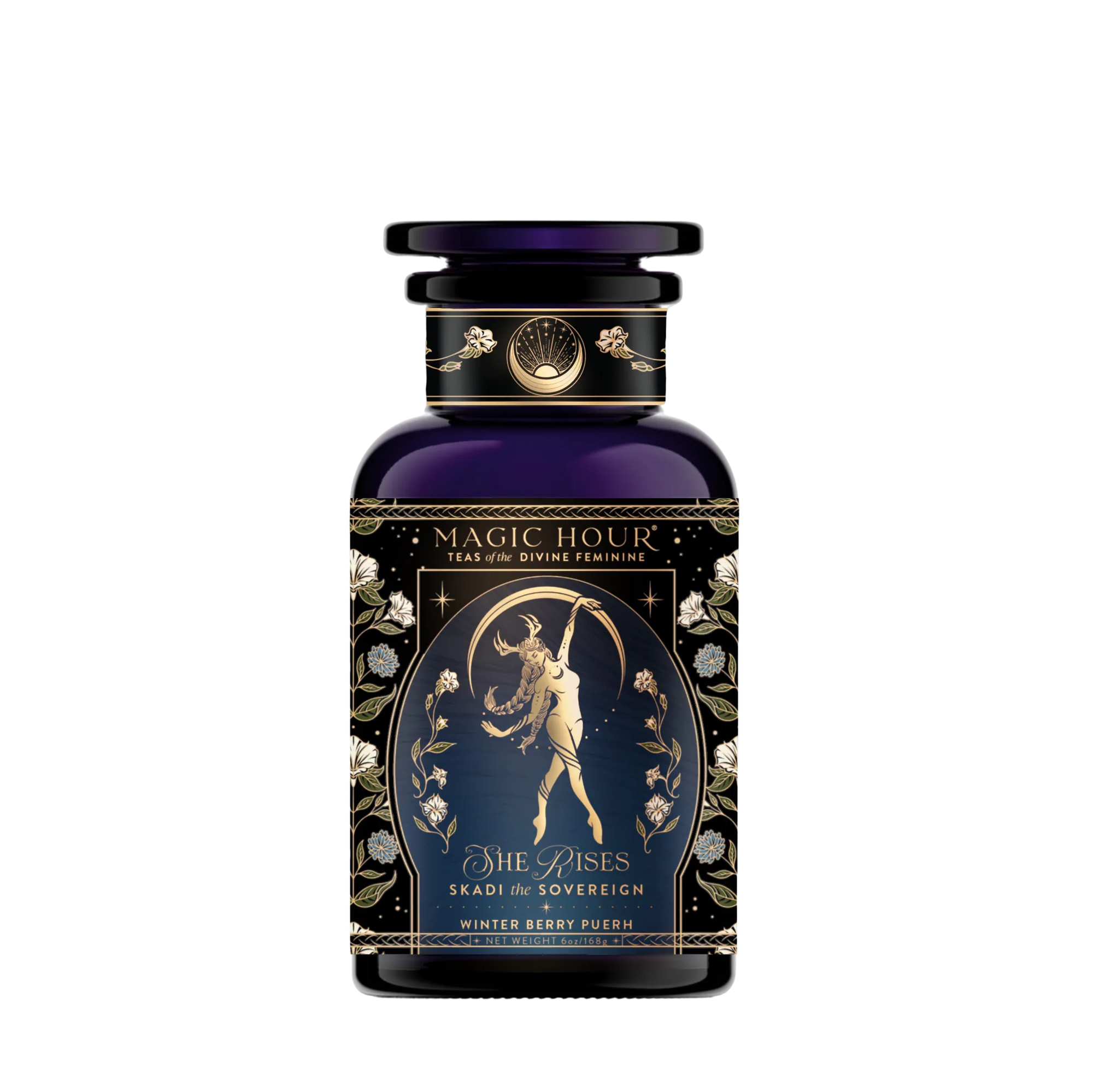 A dark blue apothecary jar labeled "Skadi The Sovereign" features a gold illustration of a woman with a bow and arrow amid floral designs, celebrating Skadi’s sovereignty with winter berry Pu-erh tea.