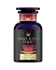 A dark purple jar with a black label reading "Magic Hour" and "Vanilla Cream Soda" with a batch number. The label also features a purple teacup on a saucer, surrounded by stars and cosmic imagery.