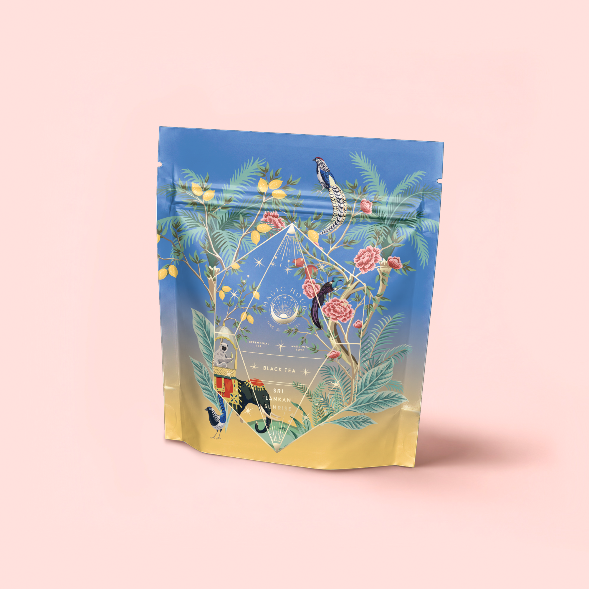 A stand-up pouch of Sri Lankan Sunrise breakfast tea features a vibrant illustrated design with tropical birds, green leaves, and pink flowers on a gradient blue and yellow background, set upon a soft pink surface.