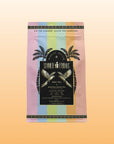 A pouch of Summer Fridays™: Mai Tai black tea, inspired by zero-proof cocktails, features pastel stripes, palm trees, and gold accents on an orange gradient background.