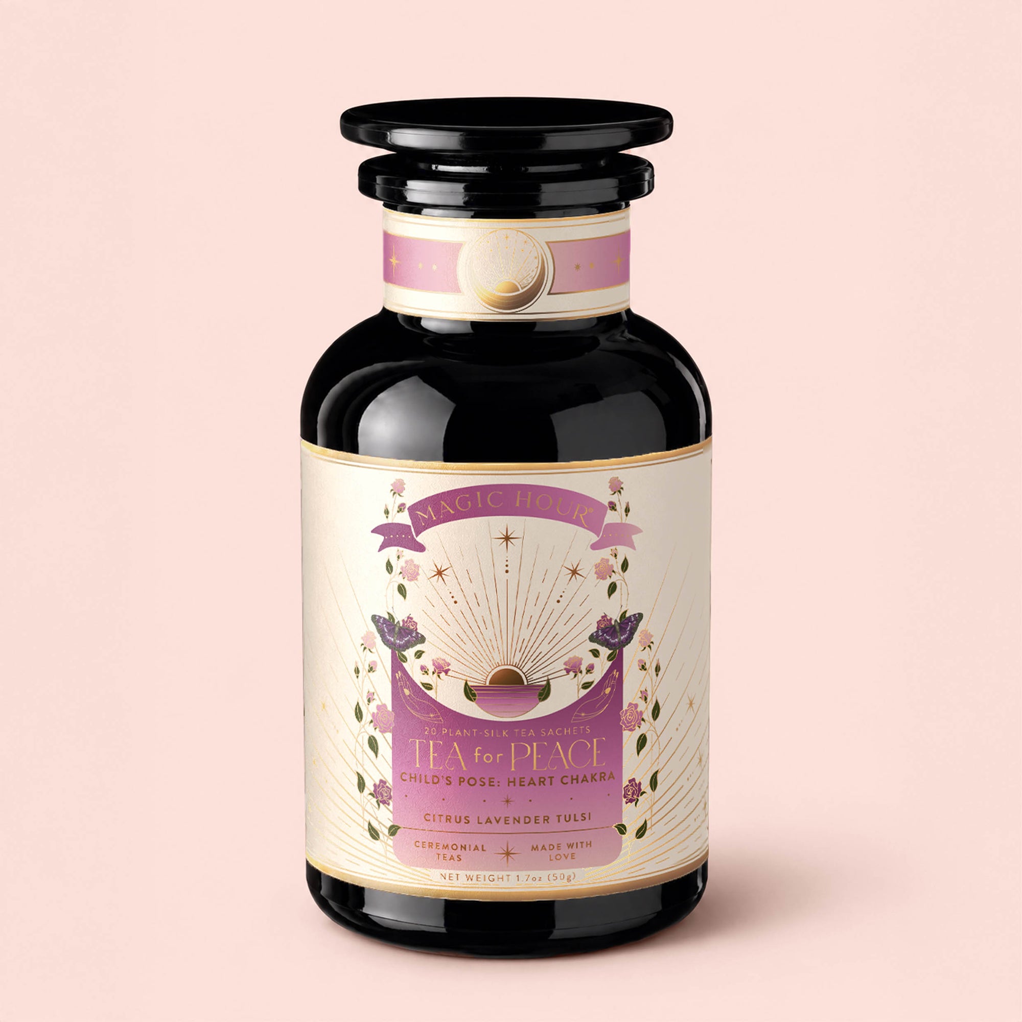 A dark glass jar labeled "Tea for Peace: Child's Pose: Citrus, Lavender &amp; Tulsi Herbal Tea Blend" features a pastel pink and cream design with gold accents, and is described as an adaptogenic tea for the heart chakra, formulated to relax your nervous system—all set against a light pink background.