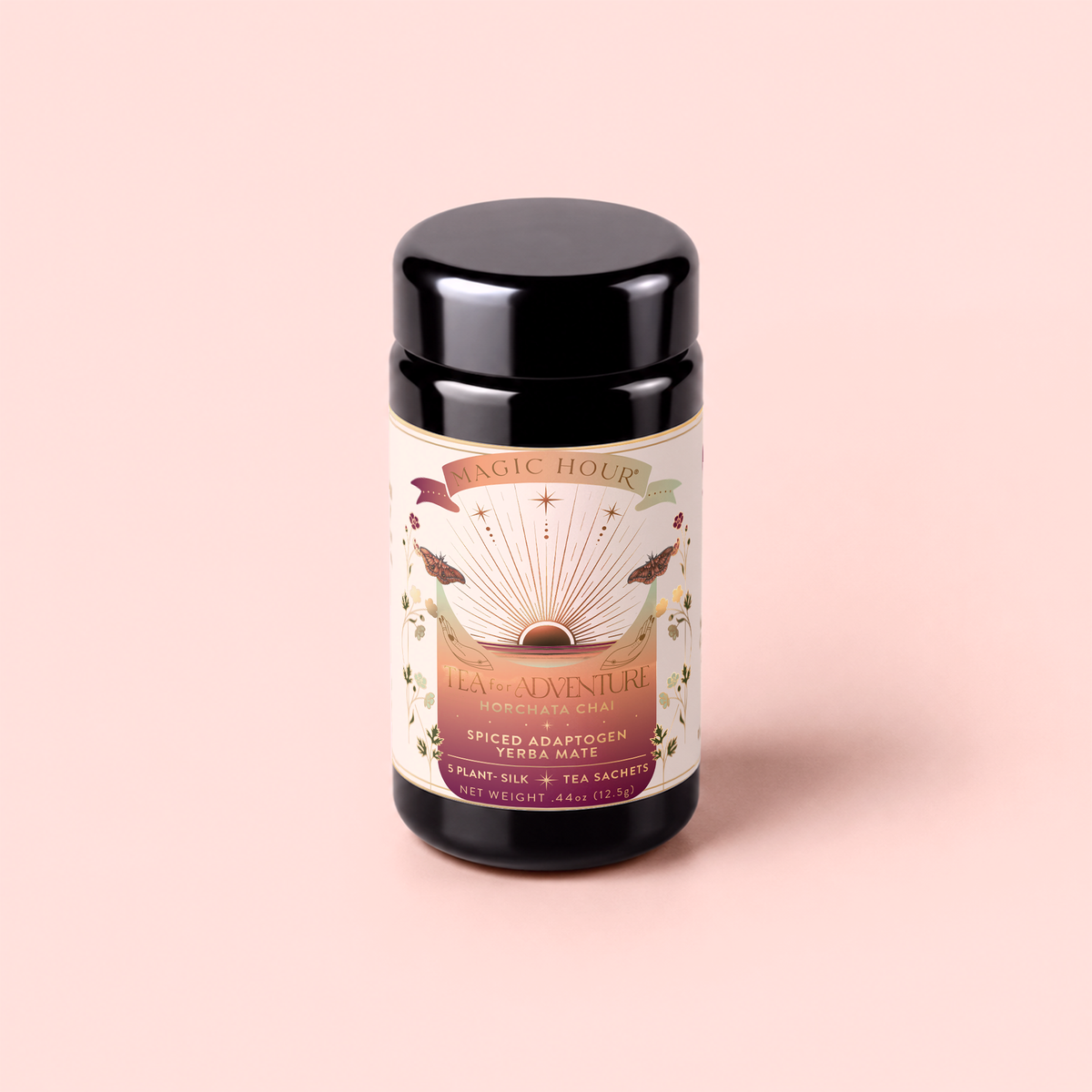 A black tea canister labeled “Tea for Adventure: Horchata Chai: Spiced Yerba Mate” with colorful artwork, described as a spiced adaptogen yerba mate horchata chai blended with Mexican vanilla bean, on a soft pink background.