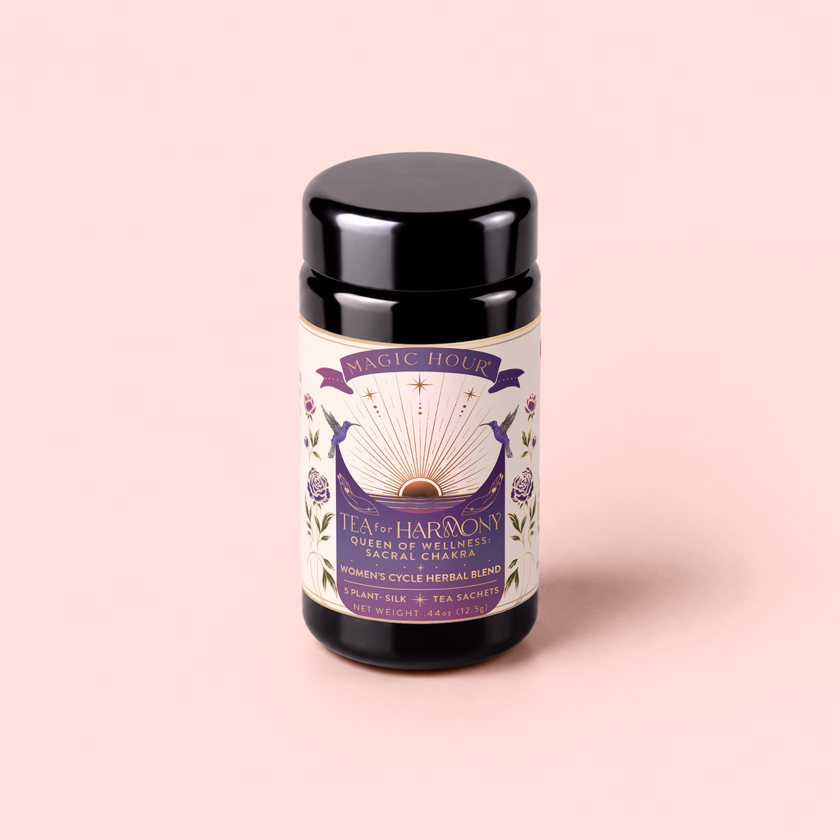 A black tea canister labeled “Tea for Harmony: Queen of Wellness: Women’s Cycle Herbal Blend” with a purple and gold design, featuring an open book, roses, and celestial motifs, sits on a light pink background—perfect for those seeking an organic feminine tea or women’s herbal tea experience.