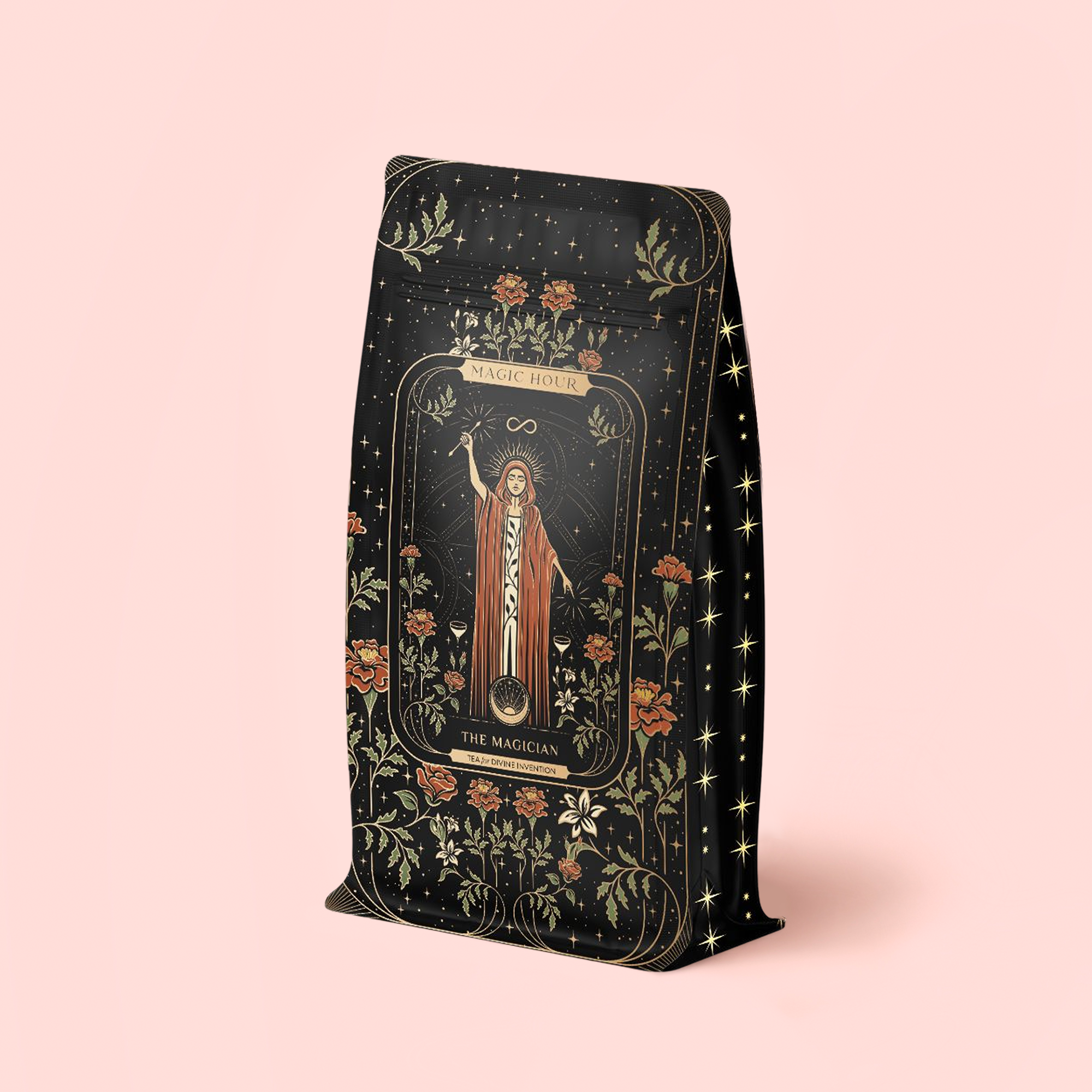 A beautifully designed black refill pouch, adorned with elegant gold, red, and green floral motifs and featuring an illustrated magician holding a wand beneath the "Magic Hour" and "The Magician" labels against a pale pink background, contains The Magician - Elderberry-Ginger-Vanilla Herbal Tea. This organic herbal blend is thoughtfully crafted to provide a variety of wellness benefits in every enchanting sip.