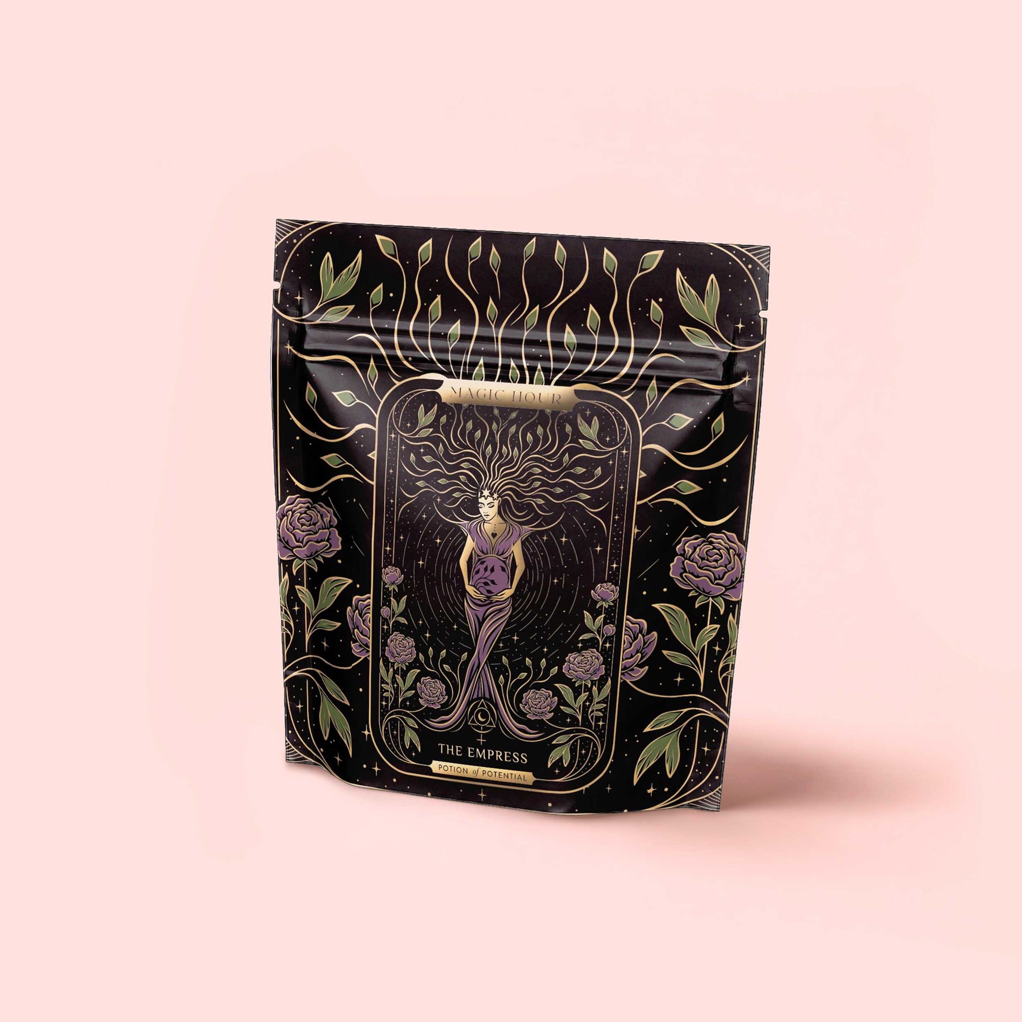 A black resealable bag labeled "The Empress: Lavender Currant Shatavari Cocoa Tea of Nurturing Creativity" features ornate, mystical art of a crowned woman amid roses, with gold, purple, and green on pale pink—perfect for organic herbal tea.