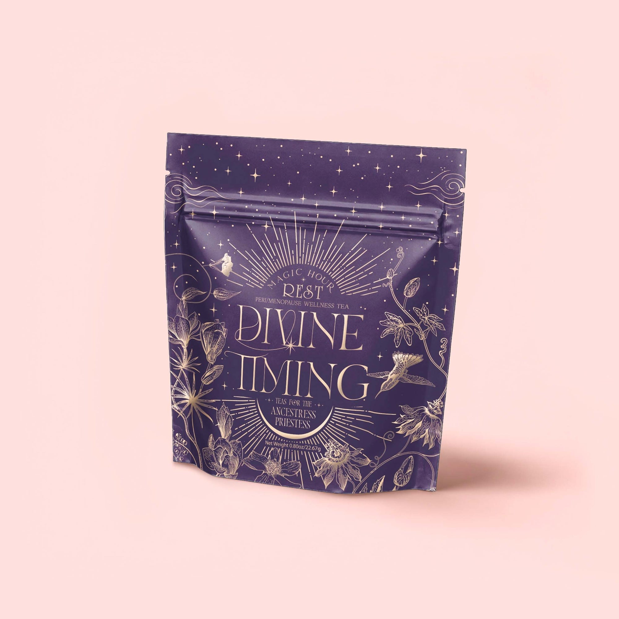 A purple resealable tea pouch labeled "Divine Timing Rest" displays gold celestial and botanical designs on a pale pink background, indicating a relaxing nighttime herbal adaptogen tea blend to support restful sleep.