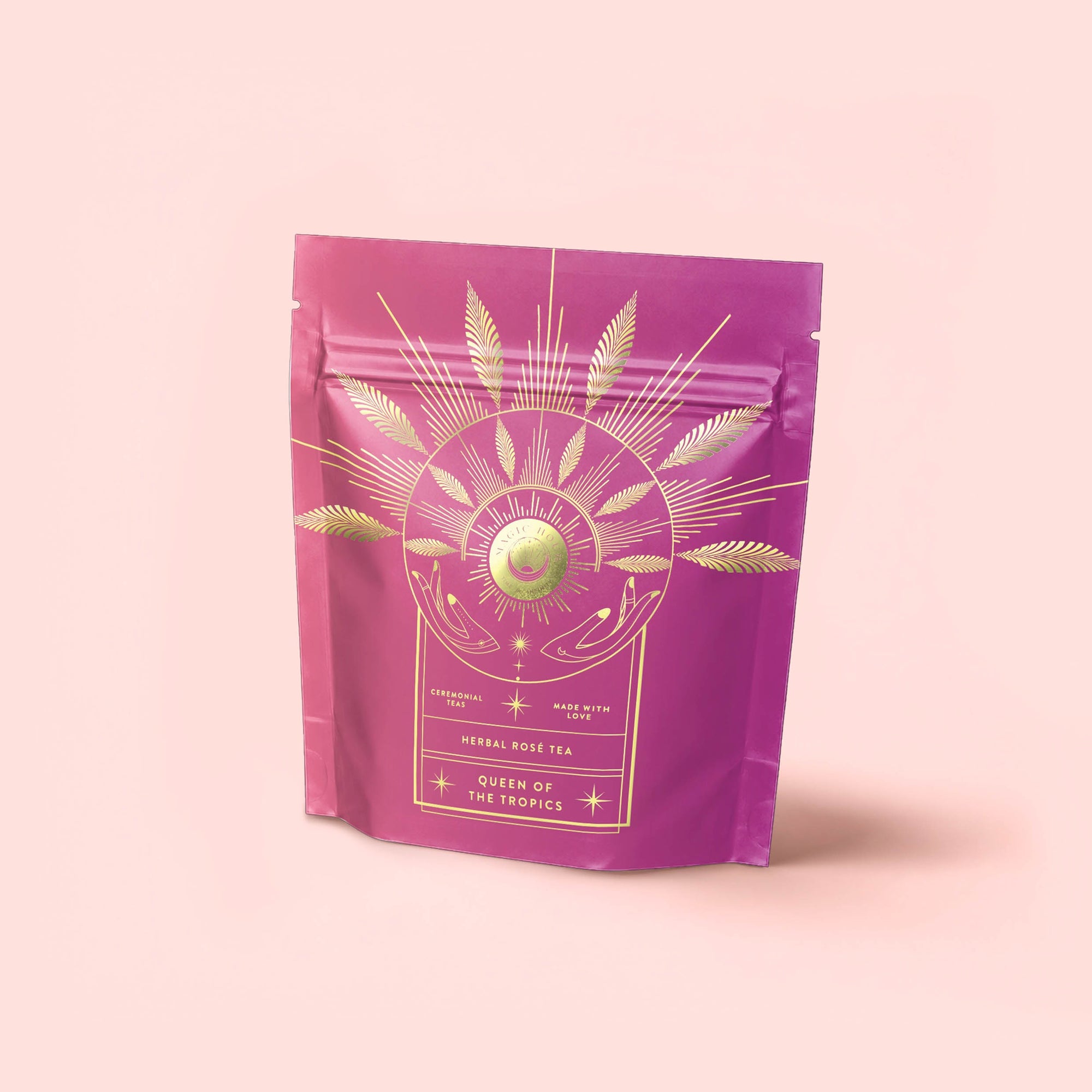 A pink and purple resealable pouch with gold leaf and orb designs is included in the Herbal Tea Sampler Tea Box: Caffeine-Free Teas for Sleep, Digestion &amp; Immunity. Enjoy with a free tea strainer.
