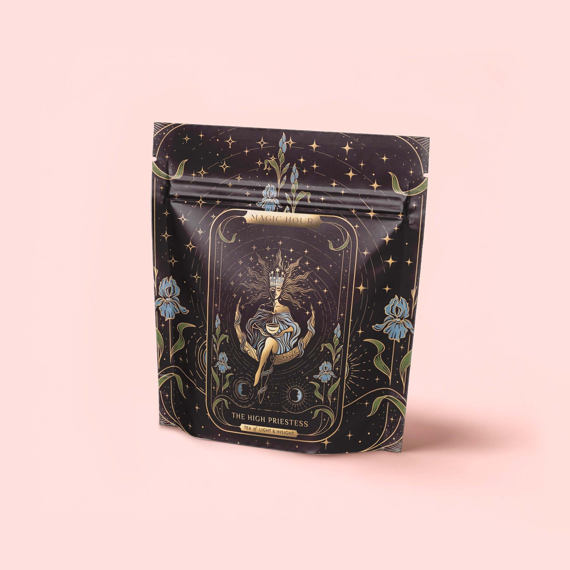 A black and gold resealable pouch adorned with a mystical tarot design labeled "The High Priestess" holds The High Priestess Ginger-Mint-Cardamom Tea: organic, caffeine-free herbal tea for powerful dreams and illuminated insights.