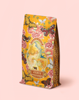 A beautifully designed tea pouch called "Venus – Tea for Beauty Sleep Refill Pouch," featuring ornate illustrations of butterflies, flowers, and a classical-style woman on a pastel pink background. This caffeine-free herbal blend contains beautifying botanicals, promising a unique infusion perfect for restful sleep.