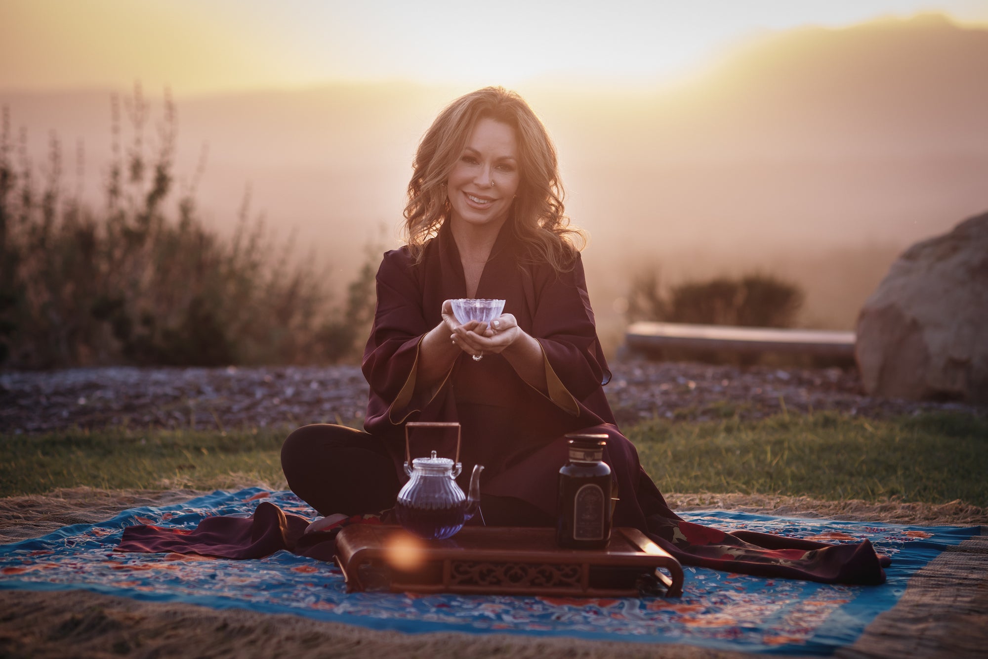 Zhena Holding a Cup of Tea at Sunset