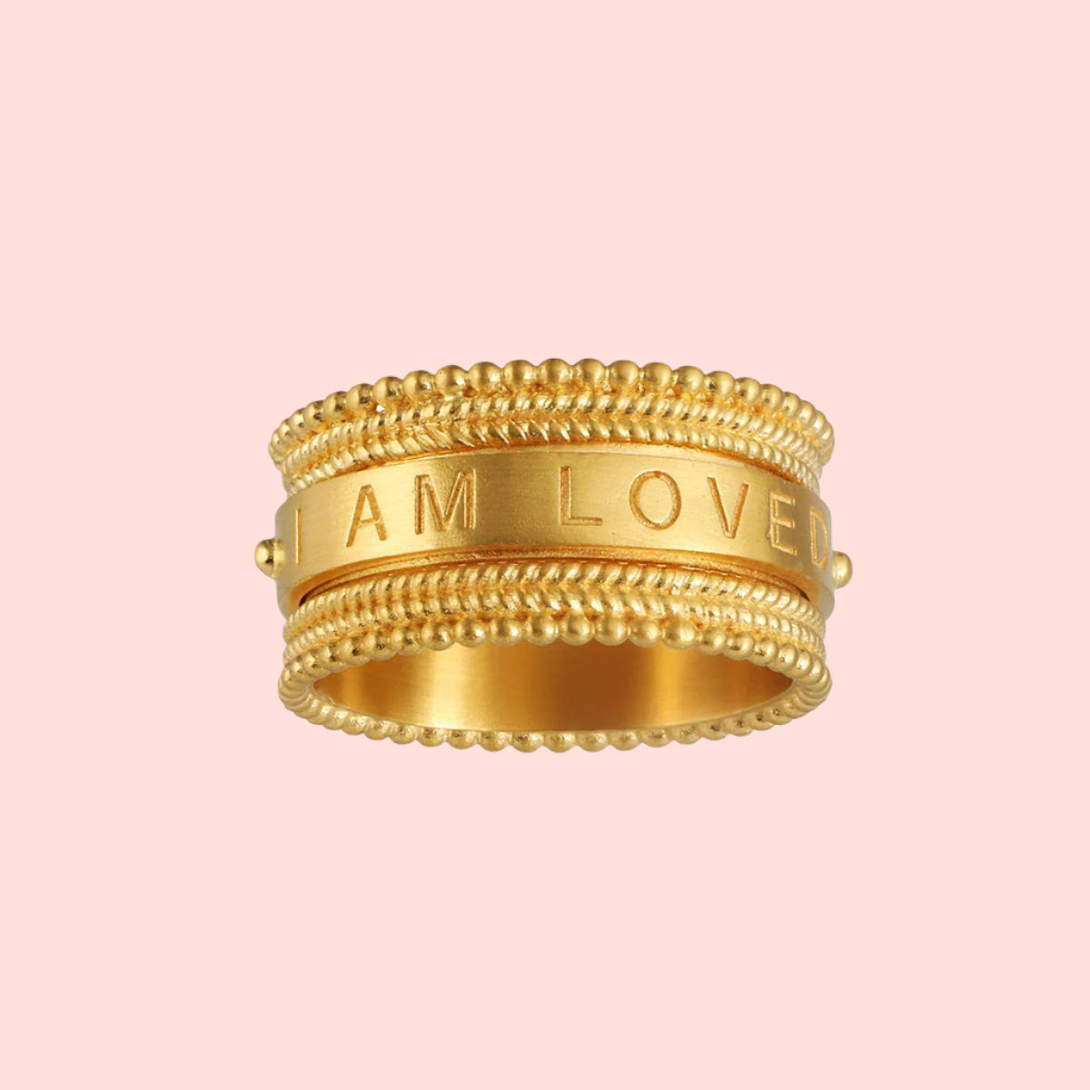 The Inner Light I Am Loved Spinning Ring, plated in 18KT gold with beaded edges, features "I AM LOVED" engraved on its smooth central band, symbolizing unconditional love against a white background.