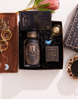 The Gemini Astrology Tea Gift Set offers a luxurious and comforting tea experience with a bottle of "Gemini Magic Hour," complemented by an indulgent blend of botanicals. Nestled on a wooden tray with a tea infuser, card, and dried herbs, it invites you to relax with its celestial charm.