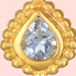 A close-up of the Inner Light Blue Topaz Pear Stud Earring, featuring a pear-shaped blue topaz set at the center and encircled by a decorative gold lotus-inspired beaded border symbolizing new beginnings.