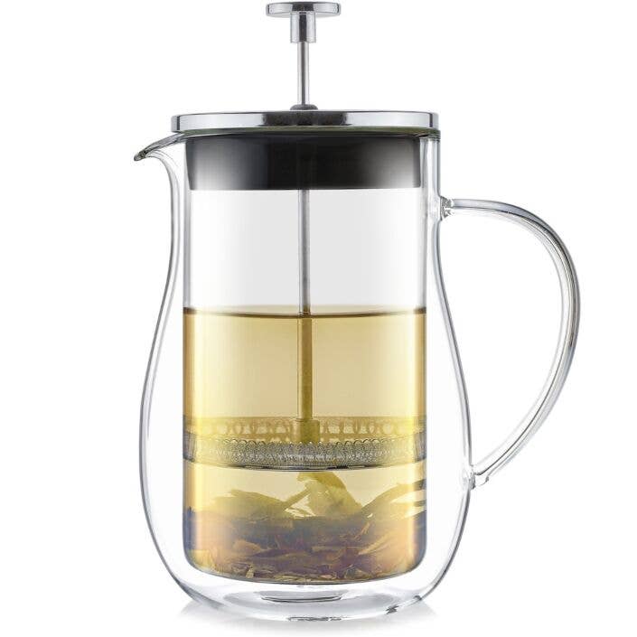 The Teabloom Louvre Insulated Double-Walled Glass French Tea Press features a clear handle, metal lid and plunger, and showcases light tea with loose leaves at the bottom—all elegantly set against a clean white background.