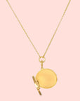 The Take Flight Butterfly Pearl Locket Necklace 18” features a round, openable locket on a delicate chain with an 18k gold plated finish, beautifully showcased against a white background.