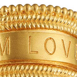Close-up of the Inner Light I Am Loved Spinning Ring, gold plated with detailed beading and &quot;I AM LOVED&quot; engraved on a smooth band, symbolizing unconditional love.