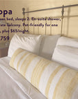 A neatly made queen bed with white linens and a yellow-striped bolster pillow sits in a cozy room with a metal headboard and soft lighting—an inviting space to unwind after immersing yourself in The Soul of Tea: A Two Day Retreat in Ojai, CA. A text overlay highlights the retreat details and pricing.