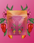 A bright packet labeled “Teasoning: Chili Fruit Spice” sits on a pink background, decorated with vivid flowers, leaves, and chili peppers, featuring bold floral and pepper designs that evoke vibrant tropical seasoning.