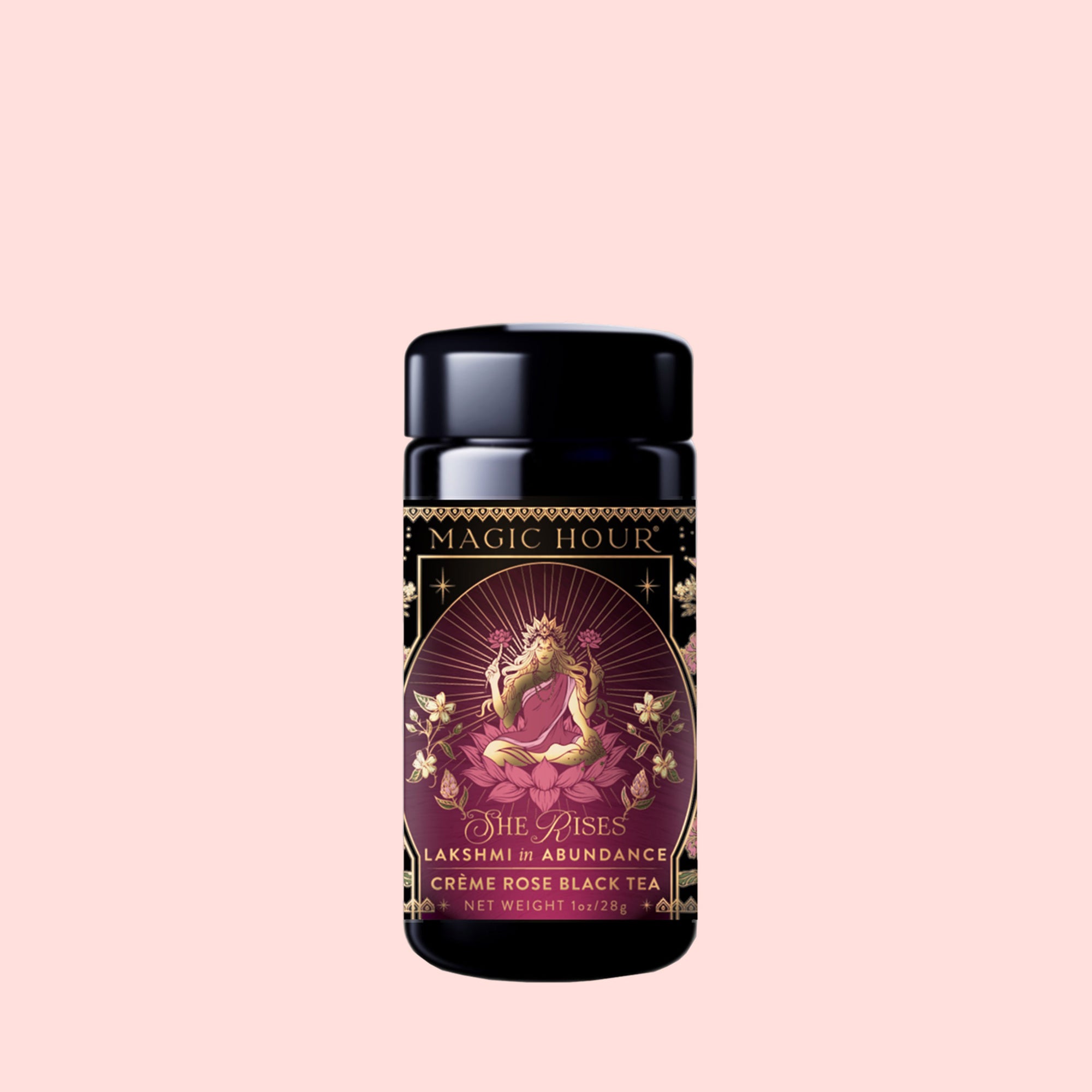 A Monthly Magic Tea Journey Subscription featuring “She Rises: Lakshmi in Abundance, Crème Rose Black Tea” arrives in a beautifully designed jar adorned with ornate artwork of a woman surrounded by lotus flowers on a soft pink background—perfect for goddess ritual tea or exploring the Divine Feminine.