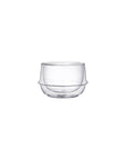 A clear double-walled glass cup with a round base and a slightly flared rim. The Kinto Double-Walled Teacups, perfect for enjoying Magic Hour Tea, appear sleek and modern against a plain white background.